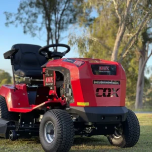 alt="Ride-on mower parked outdoors on lawn"